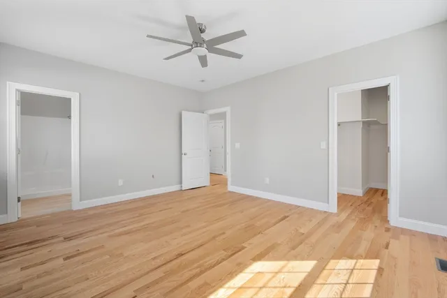 a view of an empty room and wooden floor
