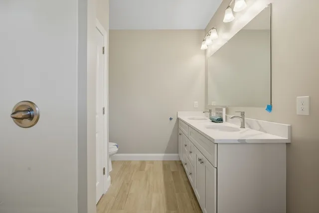 a bathroom with a double vanity sink and mirror