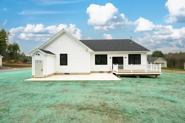 a view of a house with a yard and sitting area