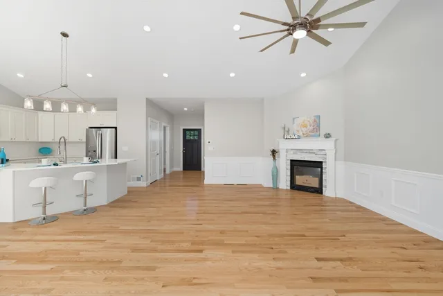 a view of an empty room and kitchen view