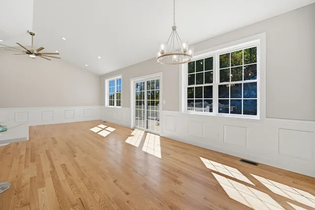 a view of empty room with a window and wooden floor
