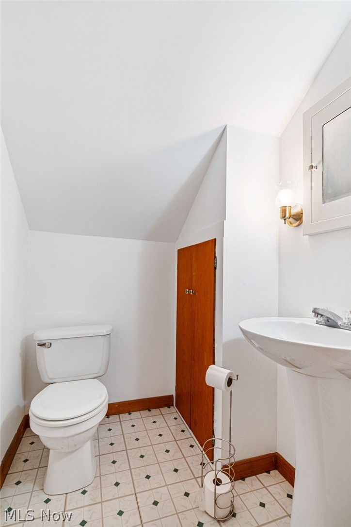 1640 Old Delaware Road Mount Vernon, OH 43050 - Photo 33 of 49 Half bathroom featuring vaulted ceiling and toilet