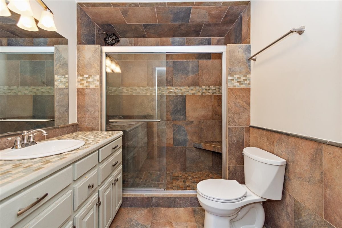 2609 Derby Run Road Springfield, TN 37172 - Photo 19 of 48 a bathroom with a granite countertop sink a toilet a mirror and shower