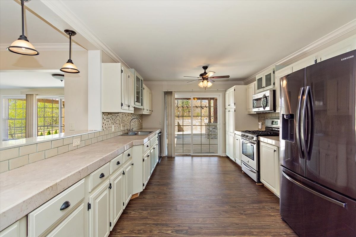2609 Derby Run Road Springfield, TN 37172 - Photo 8 of 48 a large kitchen with granite countertop a large counter top space appliances and cabinets
