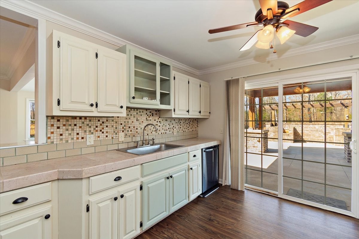 2609 Derby Run Road Springfield, TN 37172 - Photo 10 of 48 a kitchen with stainless steel appliances granite countertop a stove a sink and white cabinets with wooden floor next to windows