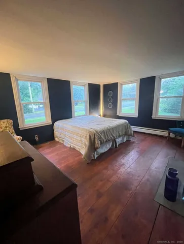 a bedroom with a bed and dresser