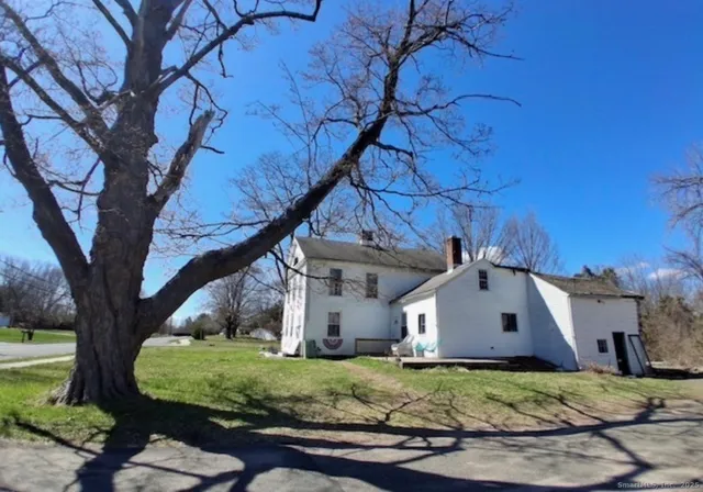a house that has a tree in front of it