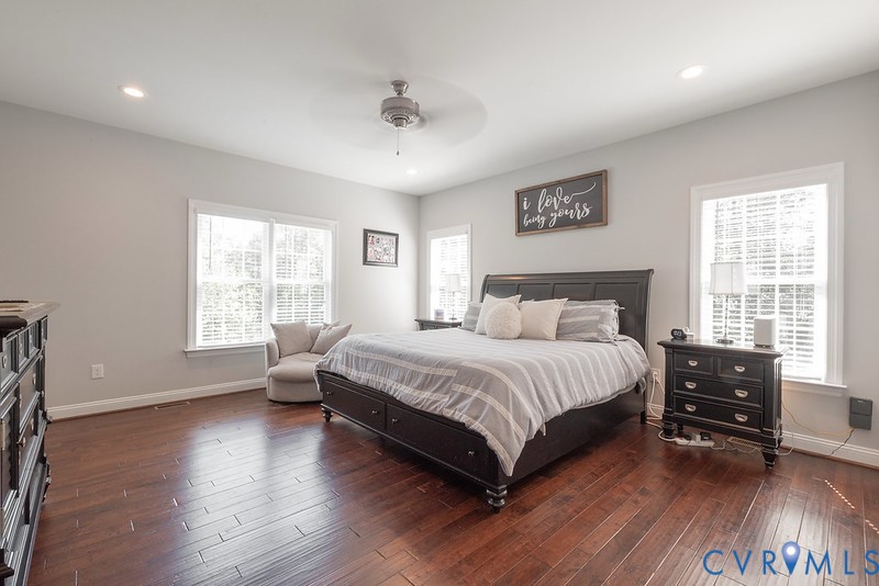 9425 Marie Road New Kent, VA 23124 - Photo 41 of 55 a spacious bedroom with a bed a dresser and wooden floor