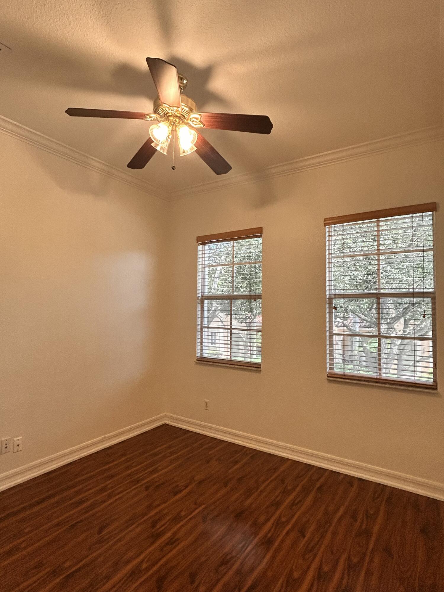 134 Ennis Lane Jupiter, FL 33458 - Photo 14 of 19 a view of an empty room with wooden floor and a window
