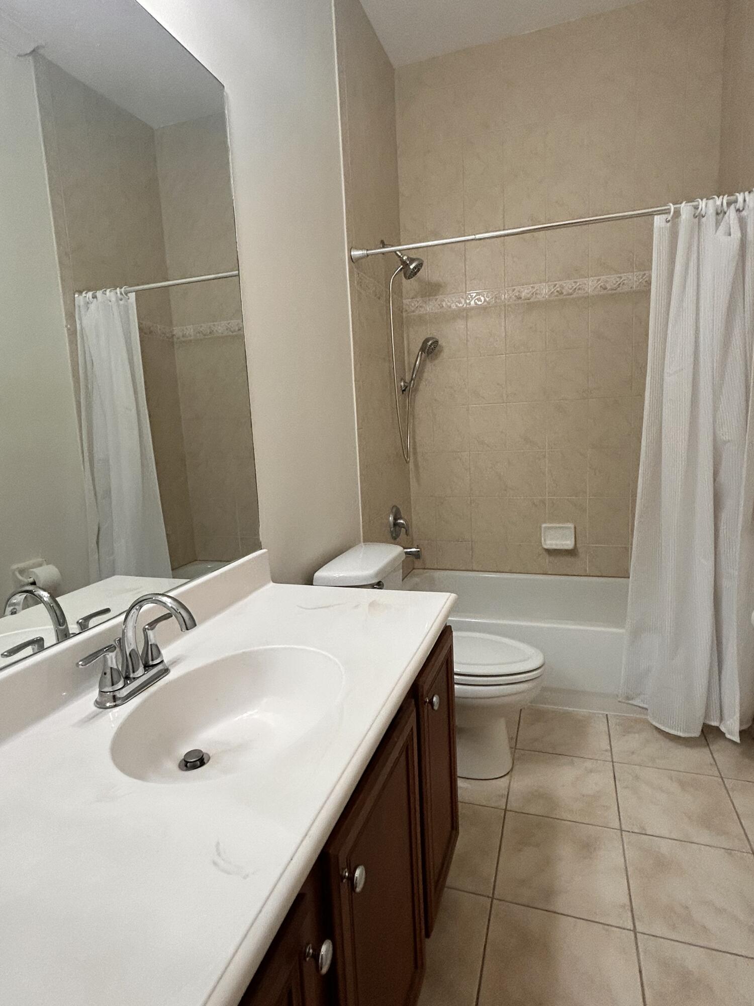 134 Ennis Lane Jupiter, FL 33458 - Photo 15 of 19 a bathroom with a sink a toilet and shower