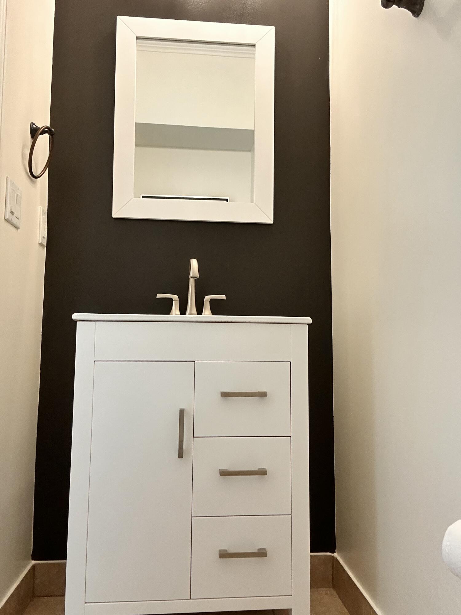 134 Ennis Lane Jupiter, FL 33458 - Photo 19 of 19 a bathroom with a sink a vanity and a mirror