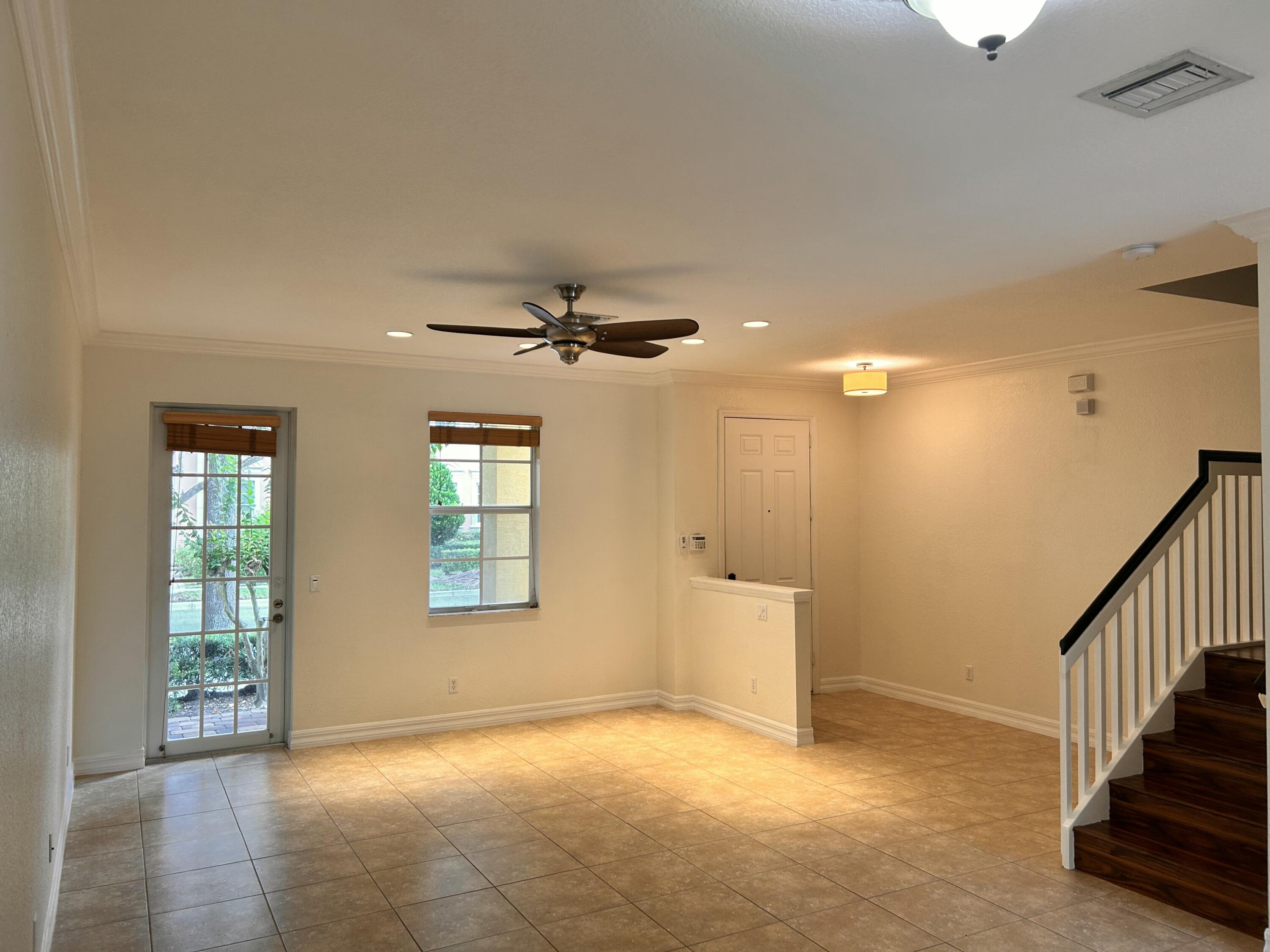 134 Ennis Lane Jupiter, FL 33458 - Photo 4 of 19 wooden floor in an empty room with a window