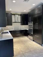 134 Ennis Lane Jupiter, FL 33458 - Photo 5 of 19 a kitchen with kitchen island a sink and a stove