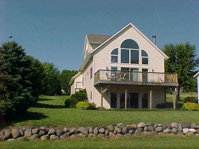 879 Breckenboro Road Lake Summerset, IL 61019 - Photo 1 of 9 a view of a white house with a yard and garage