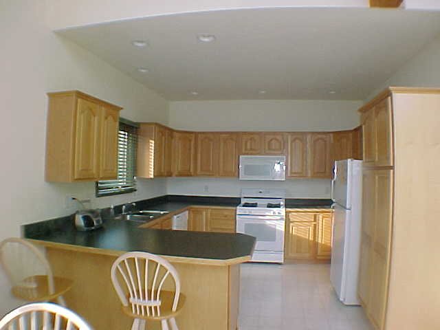 879 Breckenboro Road Lake Summerset, IL 61019 - Photo 5 of 9 a kitchen with stainless steel appliances granite countertop a sink a stove a refrigerator a counter top space and cabinets
