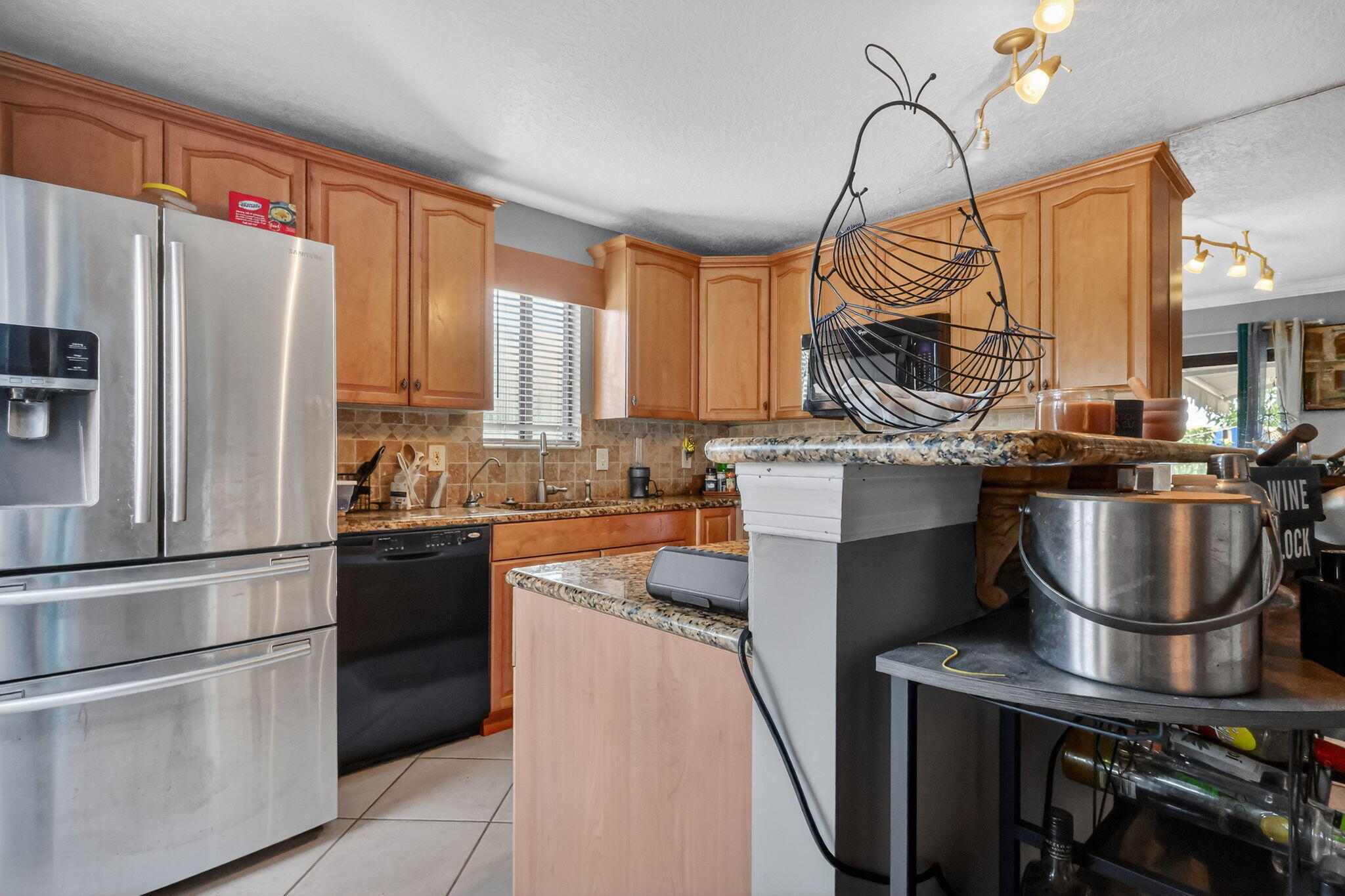 5204 Waterview Circle Palm Springs, FL 33461 - Photo 11 of 30 a kitchen with kitchen island a counter top space a sink stainless steel appliances and cabinets
