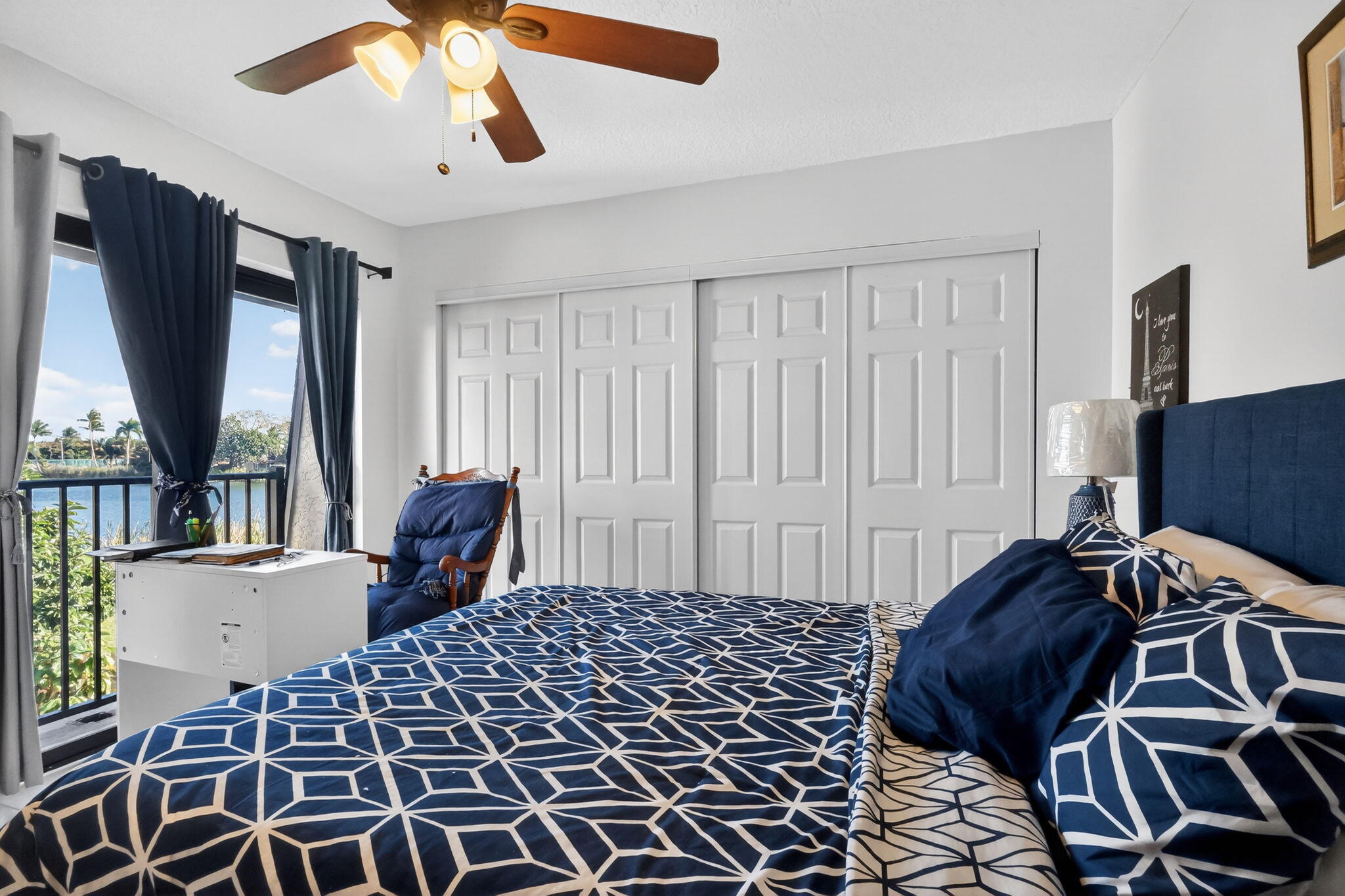 5204 Waterview Circle Palm Springs, FL 33461 - Photo 21 of 30 a bedroom with a bed and wooden floor