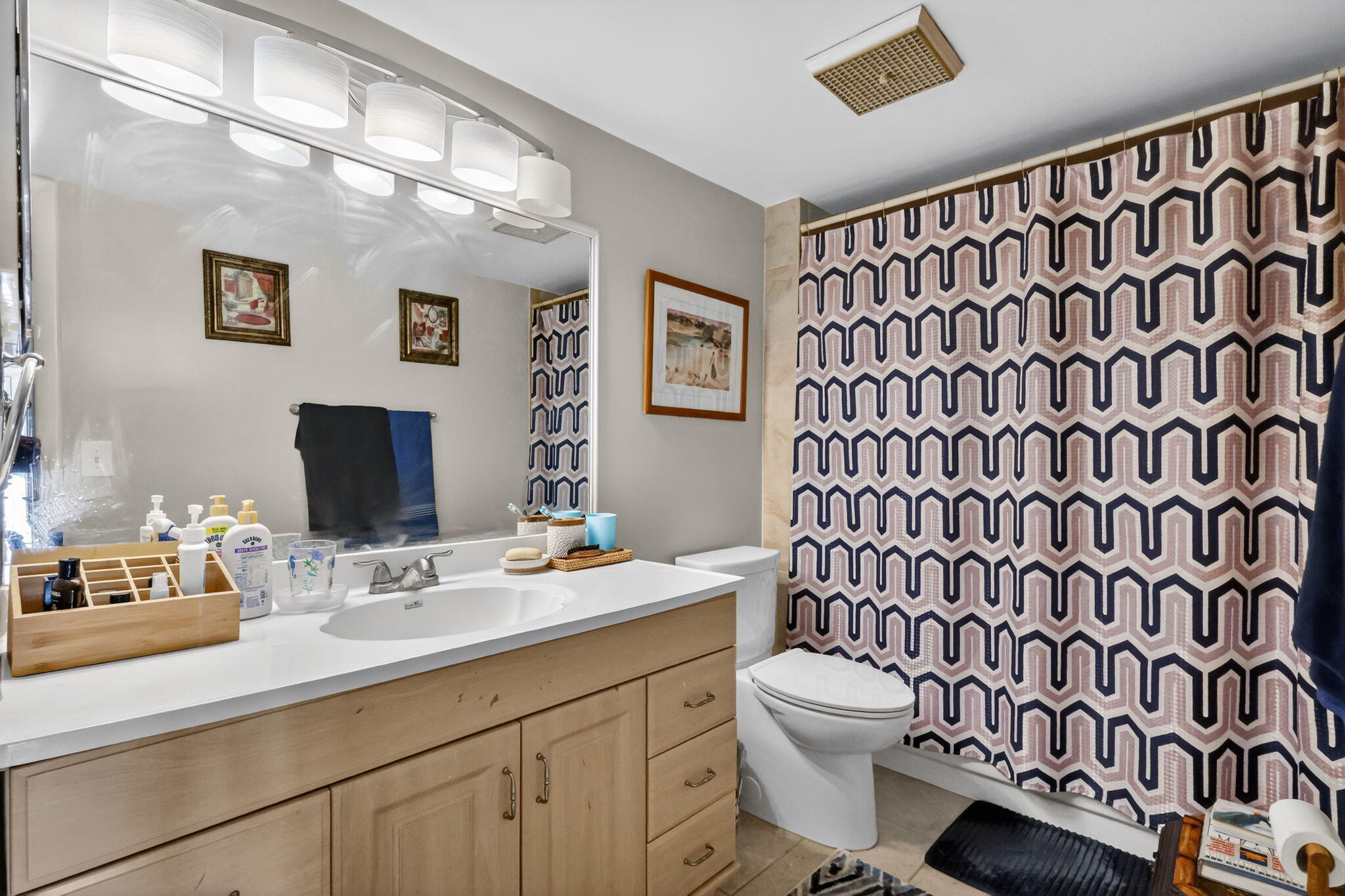 5204 Waterview Circle Palm Springs, FL 33461 - Photo 23 of 30 a bathroom with a granite countertop sink a toilet and a mirror