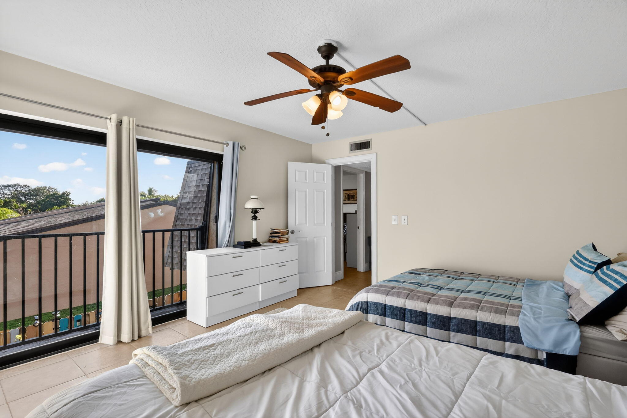 5204 Waterview Circle Palm Springs, FL 33461 - Photo 26 of 30 a bedroom with a bed and a chandelier