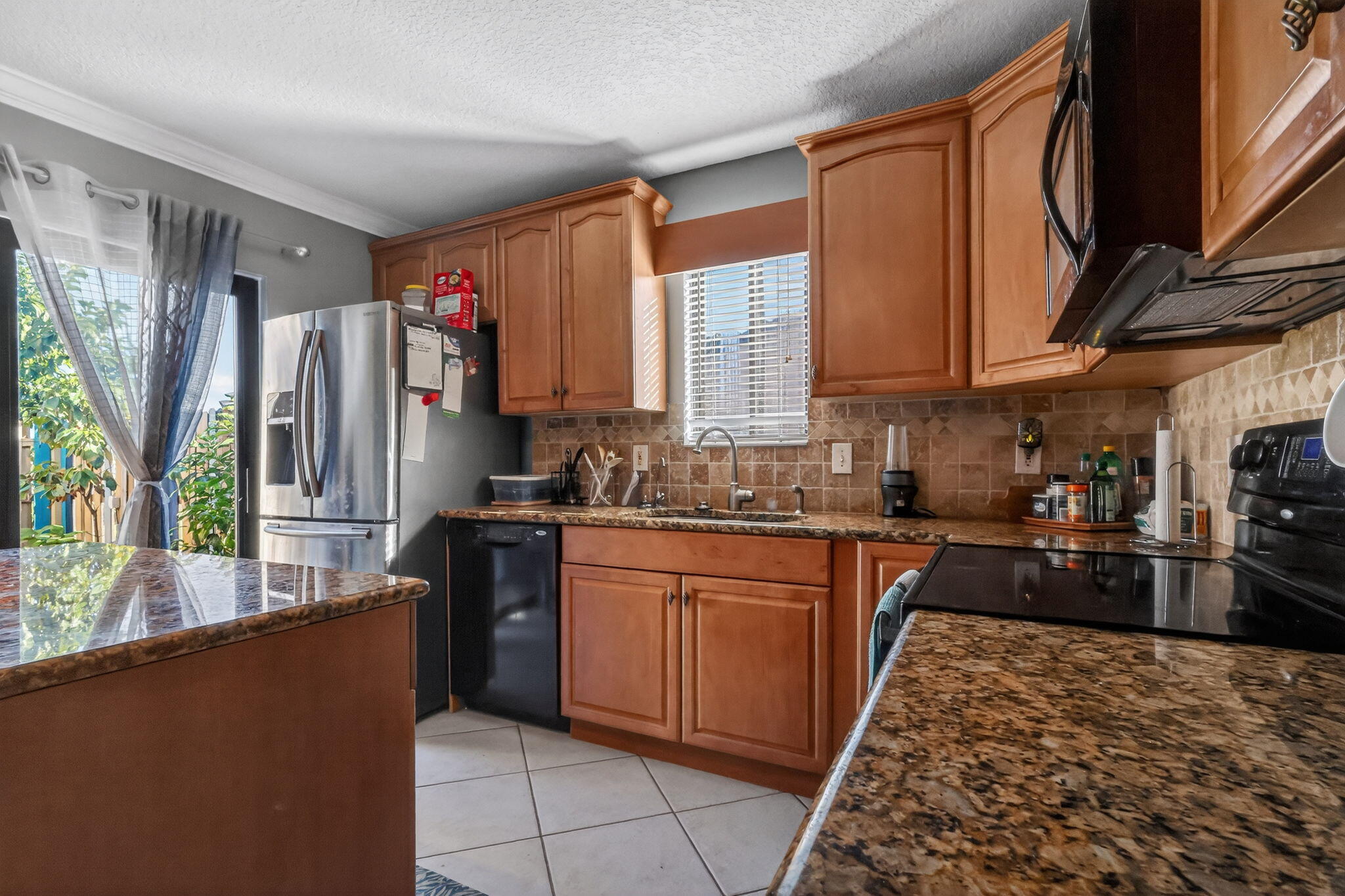 5204 Waterview Circle Palm Springs, FL 33461 - Photo 9 of 30 a kitchen with stainless steel appliances granite countertop a refrigerator sink and stove