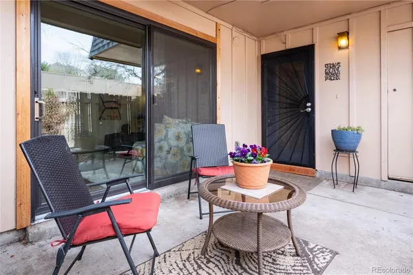 a outdoor dining space with furniture and potted plants