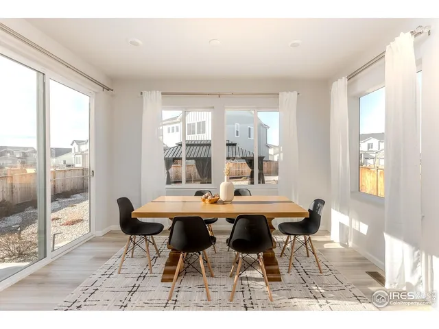 a dining room with furniture and wooden floor