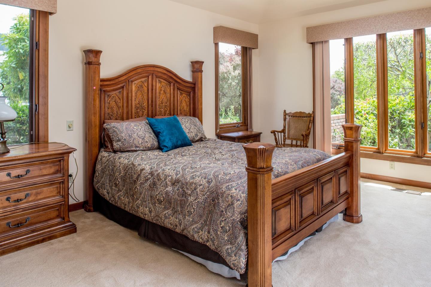 2804 Pradera Road Carmel, CA 93923 - Photo 16 of 19 a bedroom with a bed and a night stand next to a window