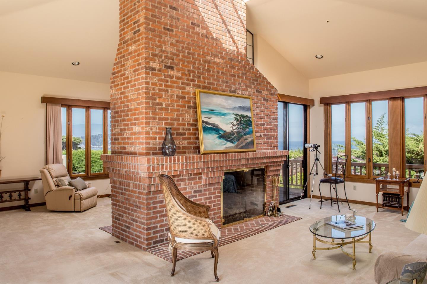 2804 Pradera Road Carmel, CA 93923 - Photo 3 of 19 a living room with furniture a fireplace and a floor to ceiling window