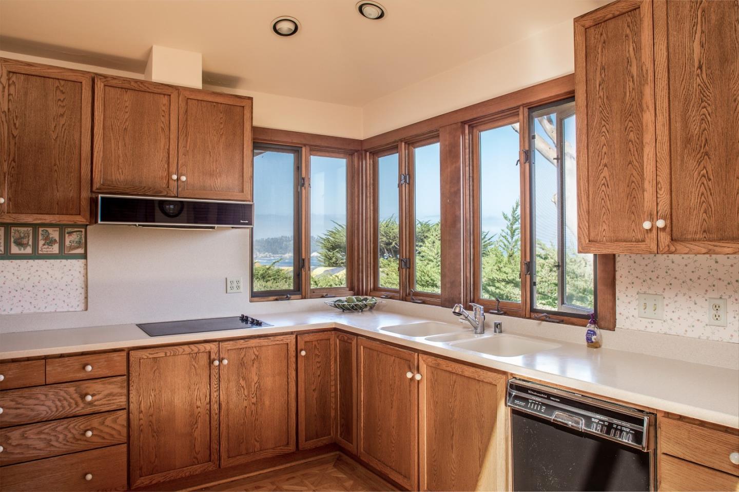 2804 Pradera Road Carmel, CA 93923 - Photo 9 of 19 a kitchen with stainless steel appliances wooden cabinets a sink and a large window