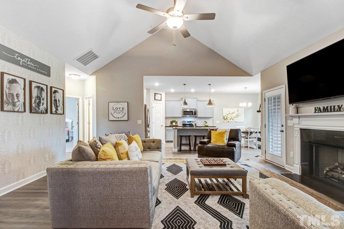 240 Northview Drive Middlesex, NC 27557 - Photo 11 of 40 a living room with furniture a flat screen tv and a fireplace
