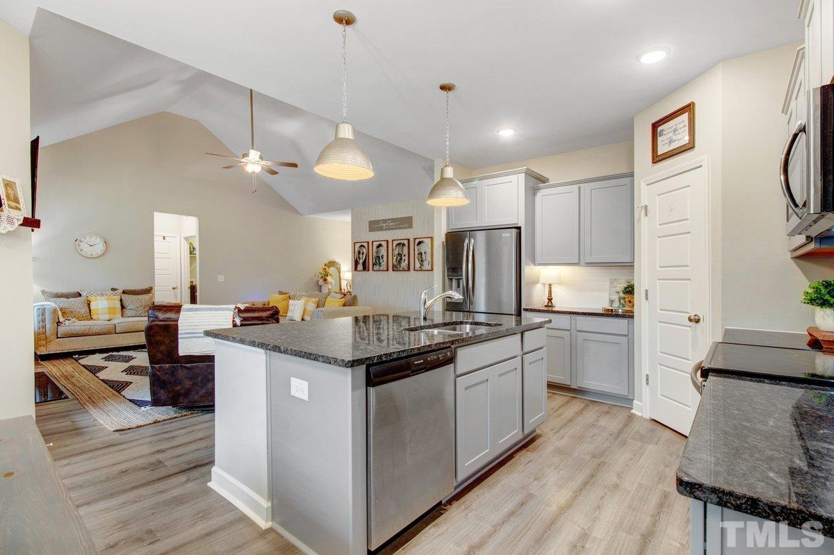 240 Northview Drive Middlesex, NC 27557 - Photo 13 of 40 a kitchen with stainless steel appliances kitchen island granite countertop a stove top oven a sink a counter top space and cabinets