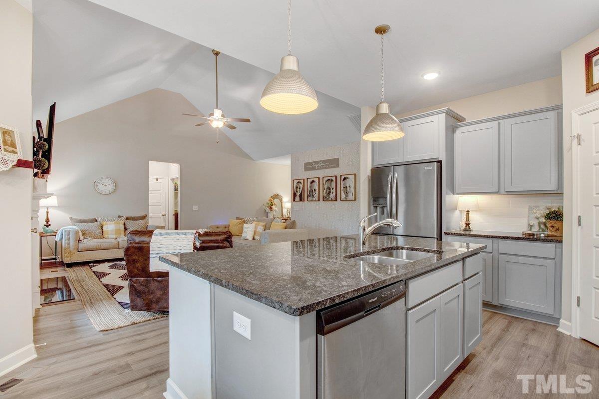 240 Northview Drive Middlesex, NC 27557 - Photo 14 of 40 a kitchen with stainless steel appliances granite countertop a sink dishwasher and refrigerator with wooden floor