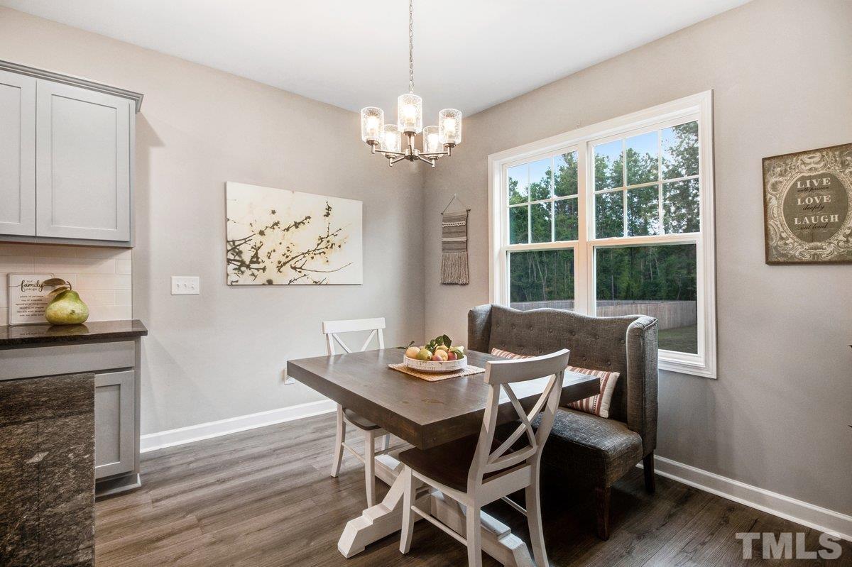240 Northview Drive Middlesex, NC 27557 - Photo 19 of 40 a view of a dining room with furniture a chandelier and wooden floor