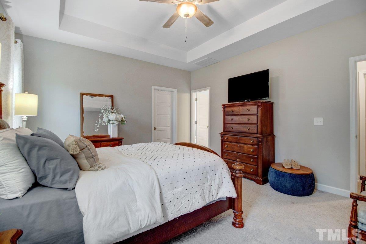 240 Northview Drive Middlesex, NC 27557 - Photo 22 of 40 a bedroom with a bed and a flat screen tv