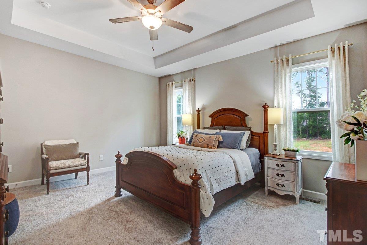 240 Northview Drive Middlesex, NC 27557 - Photo 23 of 40 a bedroom with a bed and a chandelier