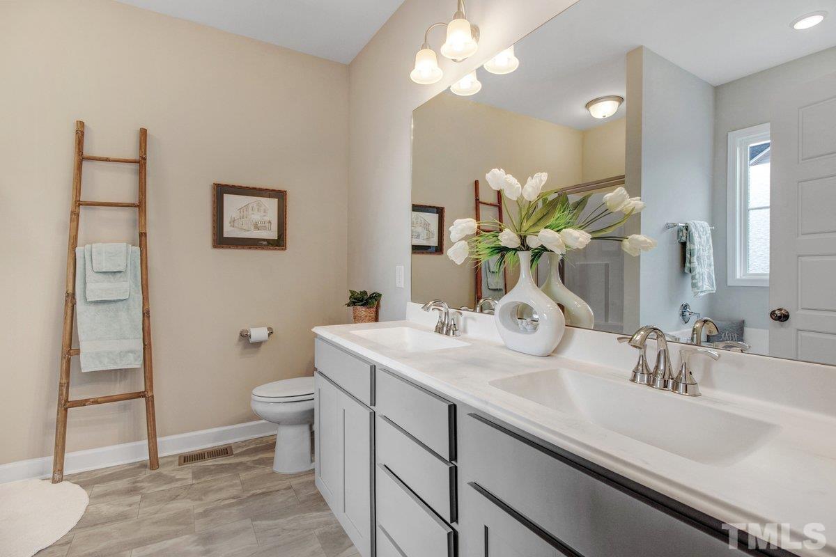 240 Northview Drive Middlesex, NC 27557 - Photo 24 of 40 a bathroom with a sink a toilet and a mirror