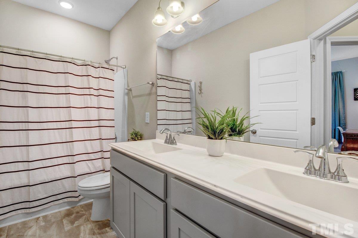 240 Northview Drive Middlesex, NC 27557 - Photo 29 of 40 a bathroom with a sink a vanity and a mirror