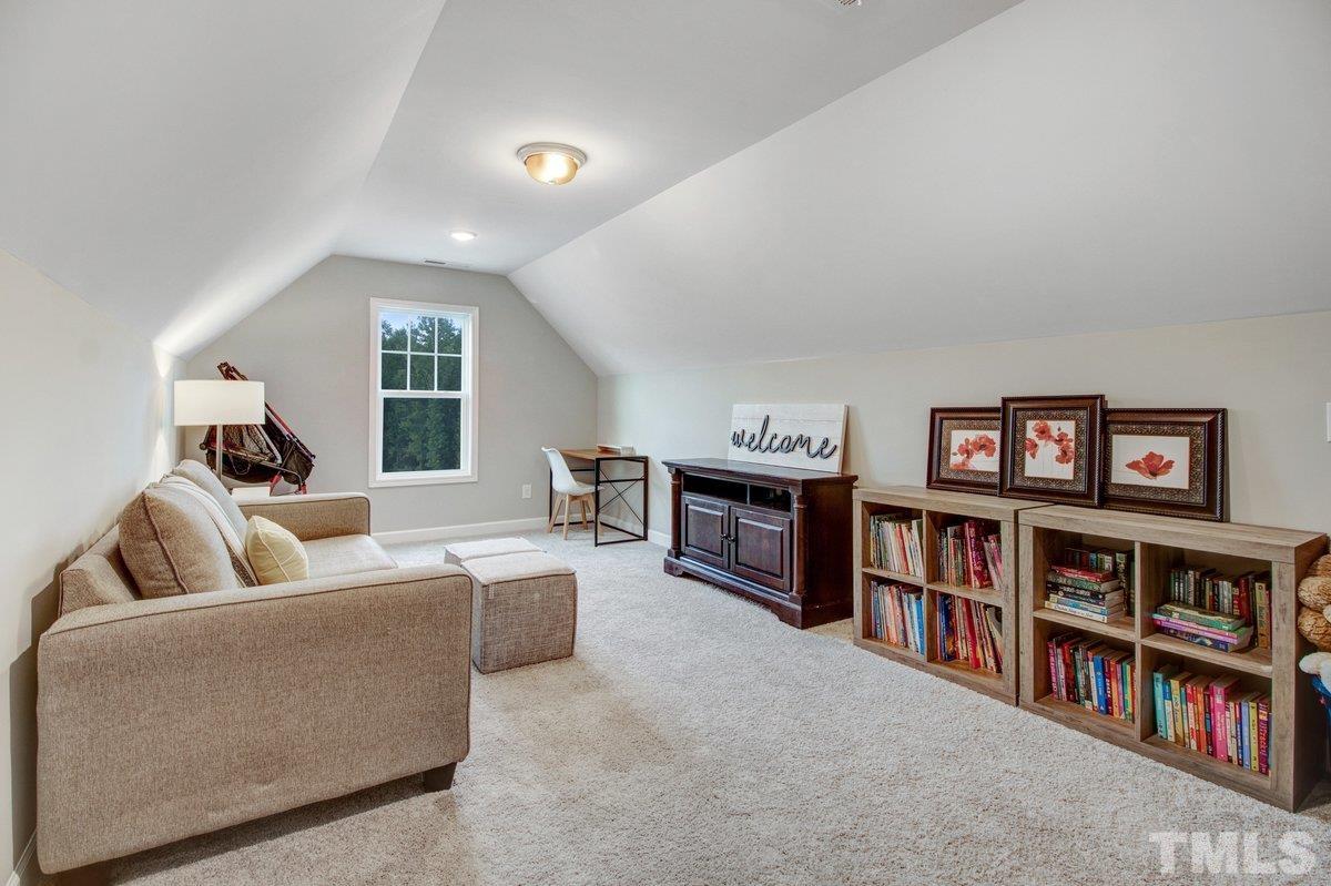 240 Northview Drive Middlesex, NC 27557 - Photo 31 of 40 a living room with a couch and a book shelf