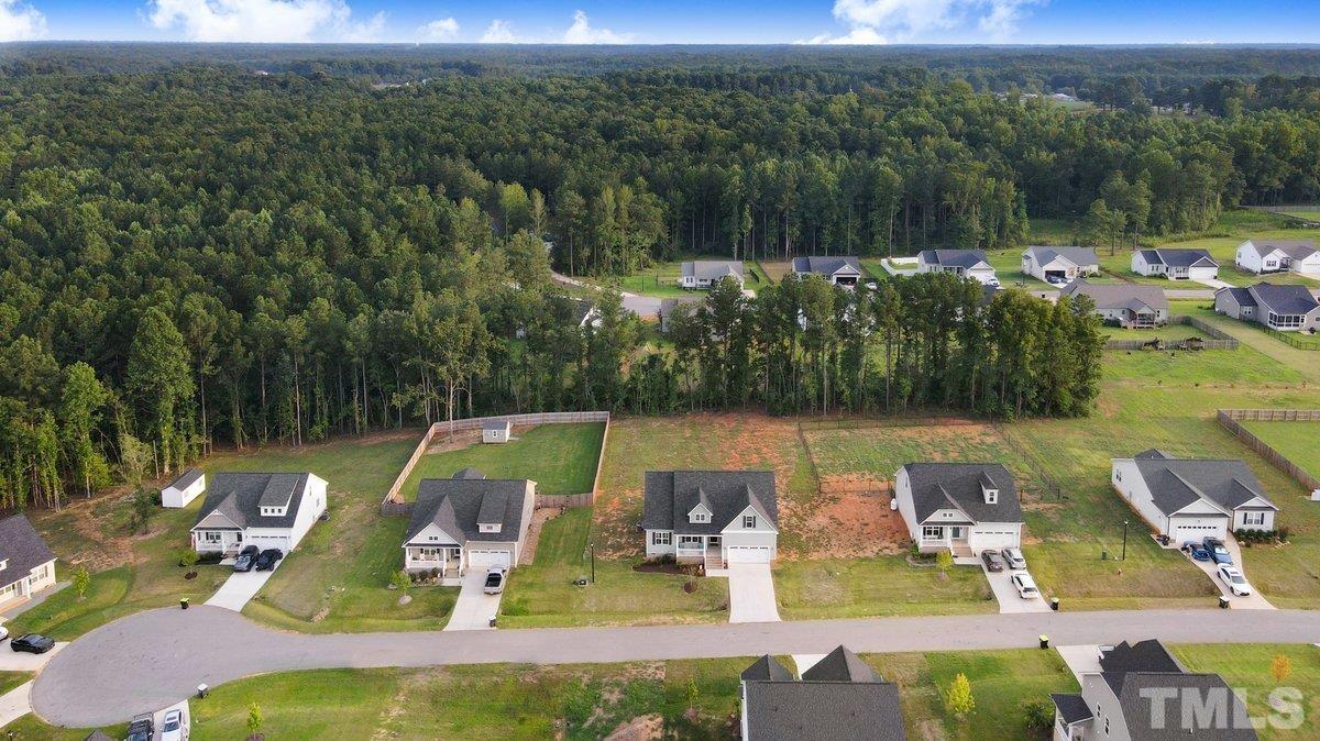 240 Northview Drive Middlesex, NC 27557 - Photo 6 of 40 a view of swimming pool with seating area and trees in the background