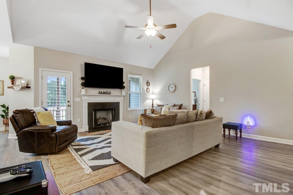 240 Northview Drive Middlesex, NC 27557 - Photo 10 of 40 a living room with furniture a flat screen tv and a fireplace