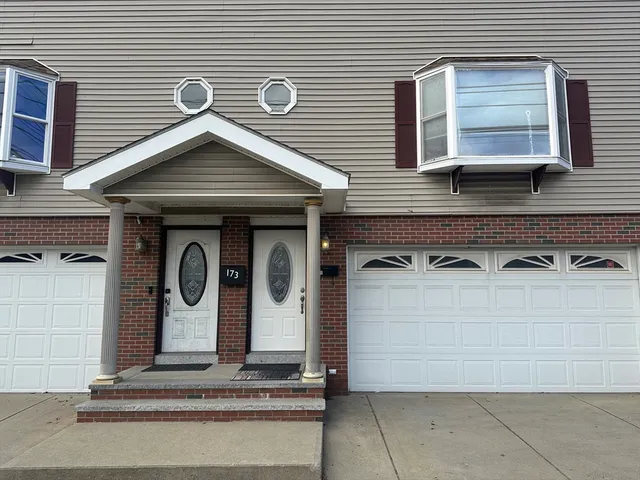 a front view of a house with garage