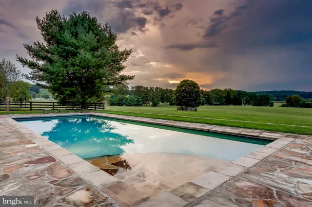 a view of a swimming pool and a yard