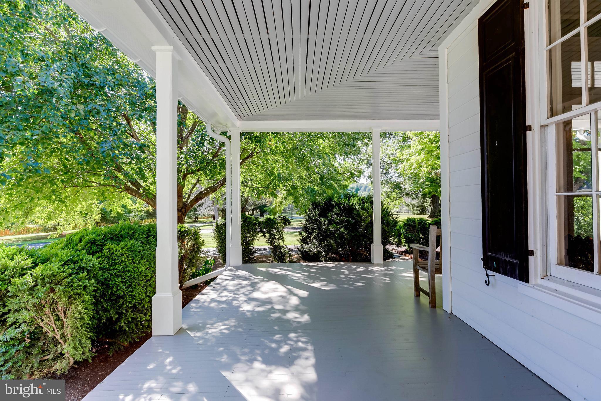 13401 Longnecker Road Reisterstown, MD 21136 - Photo 57 of 58 a view of a patio with table and chairs in front of a yard with lawn chairs