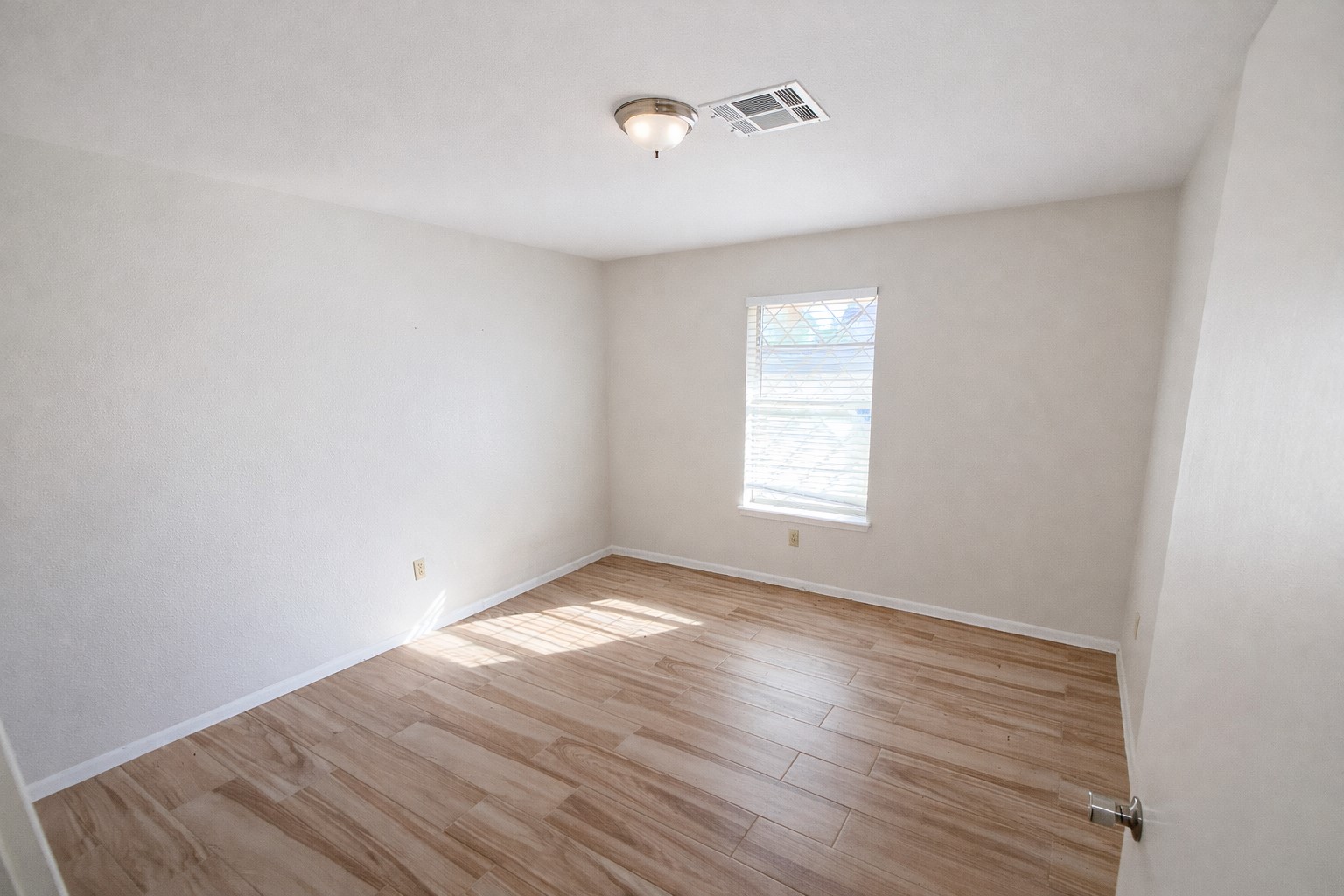 21547 Binford Road Waller, TX 77484 - Photo 5 of 19 an empty room with wooden floor and windows