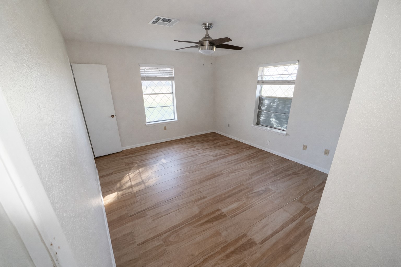 21547 Binford Road Waller, TX 77484 - Photo 6 of 19 a view of an empty room with a window and wooden floor