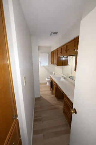 a large white kitchen with sink and washing machine