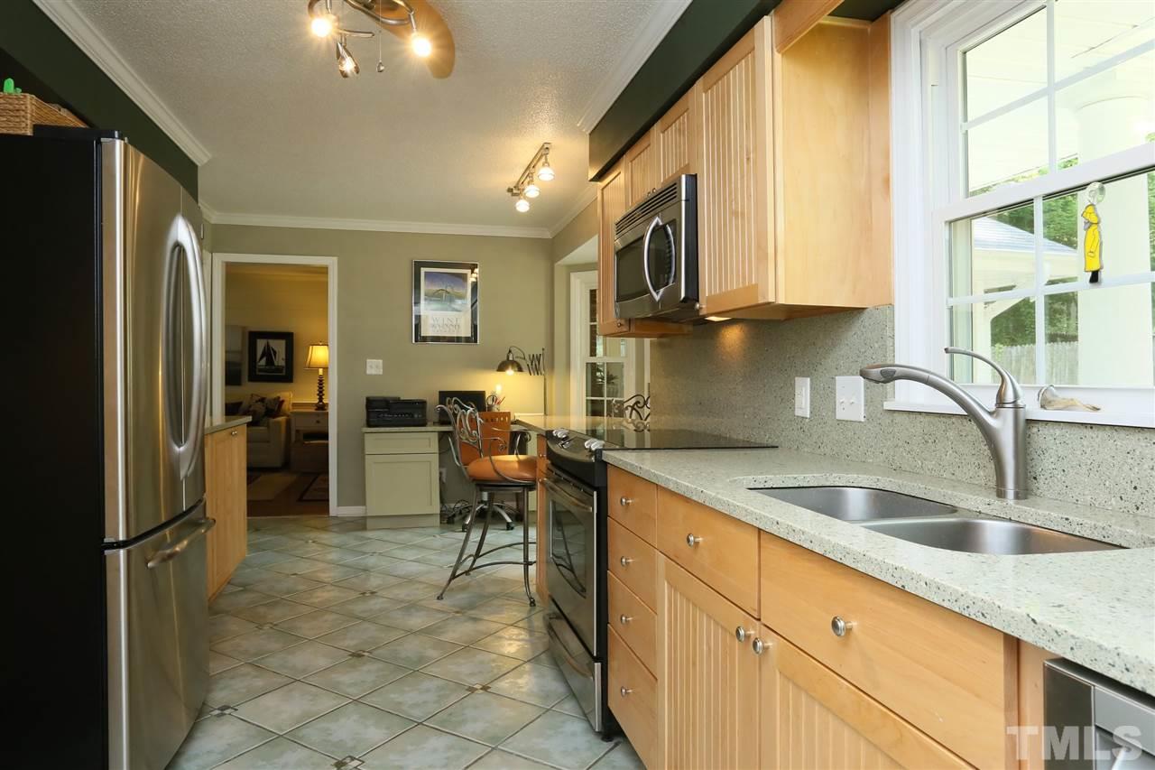 4505 Old Colony Road Raleigh, NC 27613 - Photo 14 of 30 a kitchen with stainless steel appliances granite countertop a sink and a refrigerator
