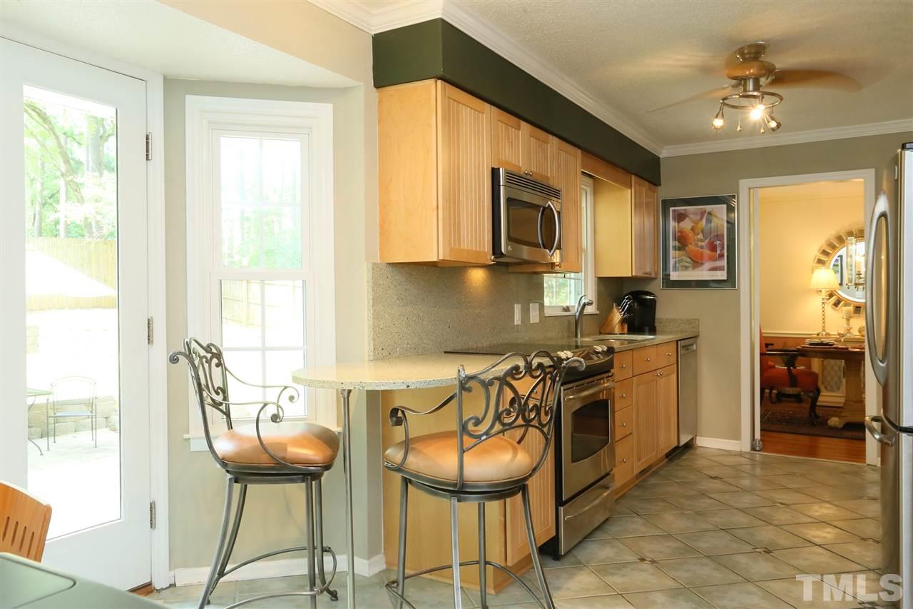 4505 Old Colony Road Raleigh, NC 27613 - Photo 15 of 30 a kitchen with stainless steel appliances granite countertop a stove and a refrigerator
