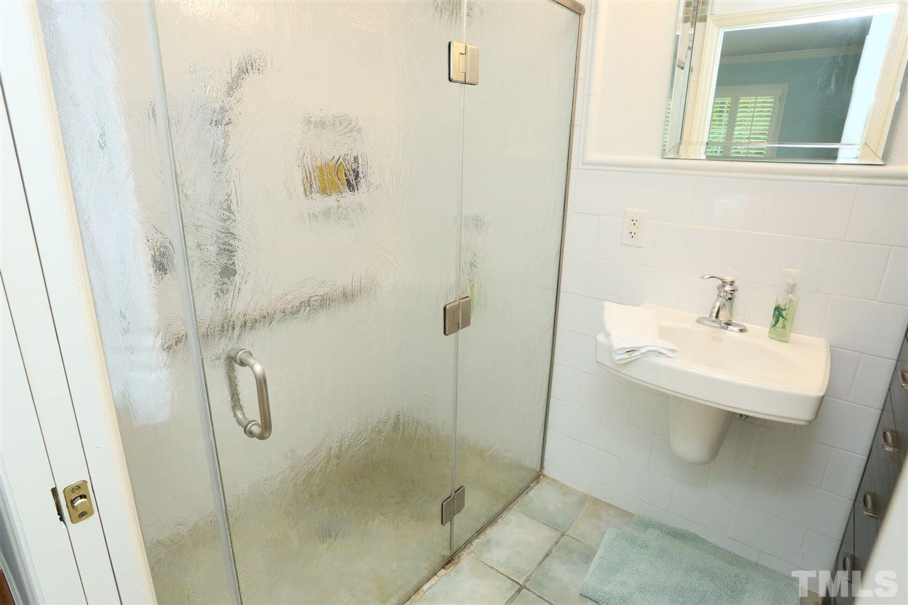 4505 Old Colony Road Raleigh, NC 27613 - Photo 20 of 30 a bathroom with a shower a sink and mirror