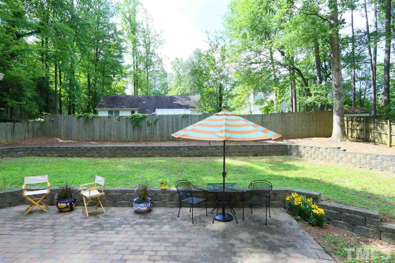 4505 Old Colony Road Raleigh, NC 27613 - Photo 3 of 30 a view of a table and chairs under an umbrella